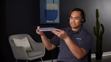 Product expert holding up a Surface device